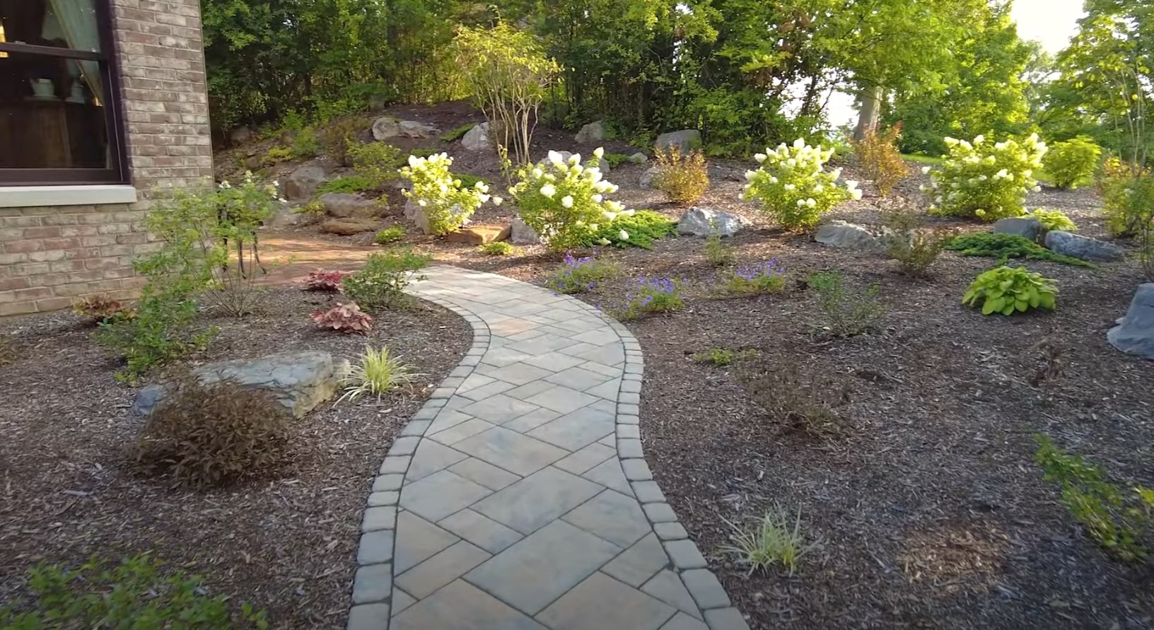 Hardscaping with Native Plants and Stone Walkways Professional hardscape design with natural stone pathways and native plant landscaping