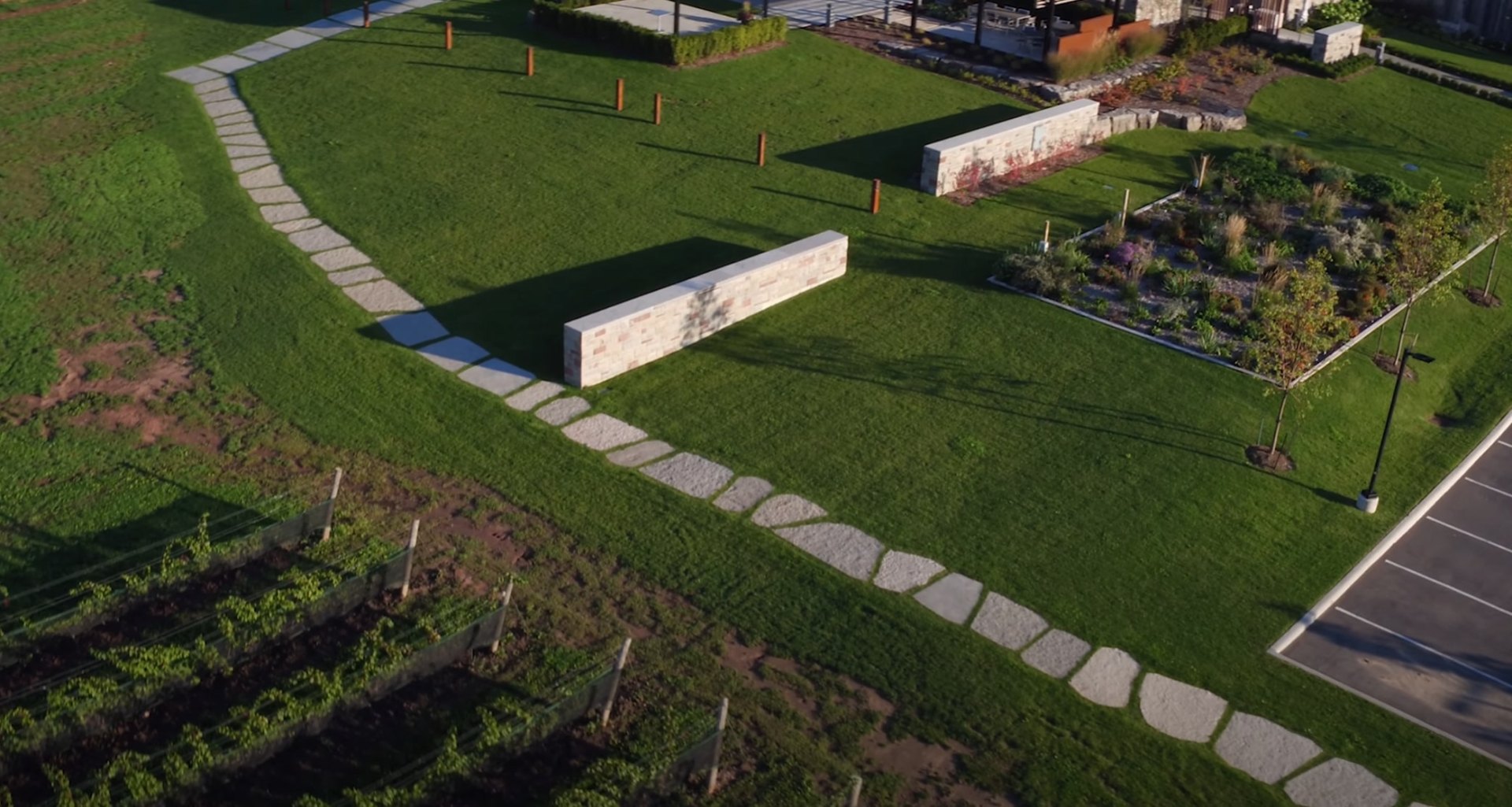 Custom Hardscaping with Stone Pathways and Geometric Lawn Design Aerial landscape design featuring curved stone pathways, geometric lawn patterns, and modern hardscaping elements