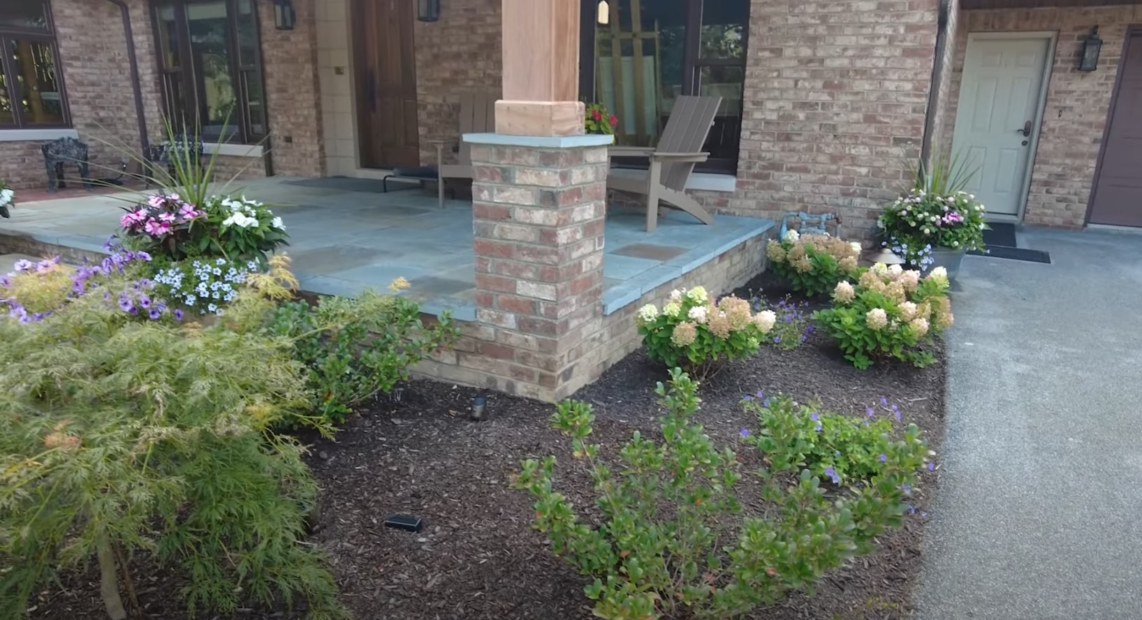 Seasonal Landscaping Design with Beautiful Flower Arrangements Modern home landscaping with professional flower bed design and seasonal plantings